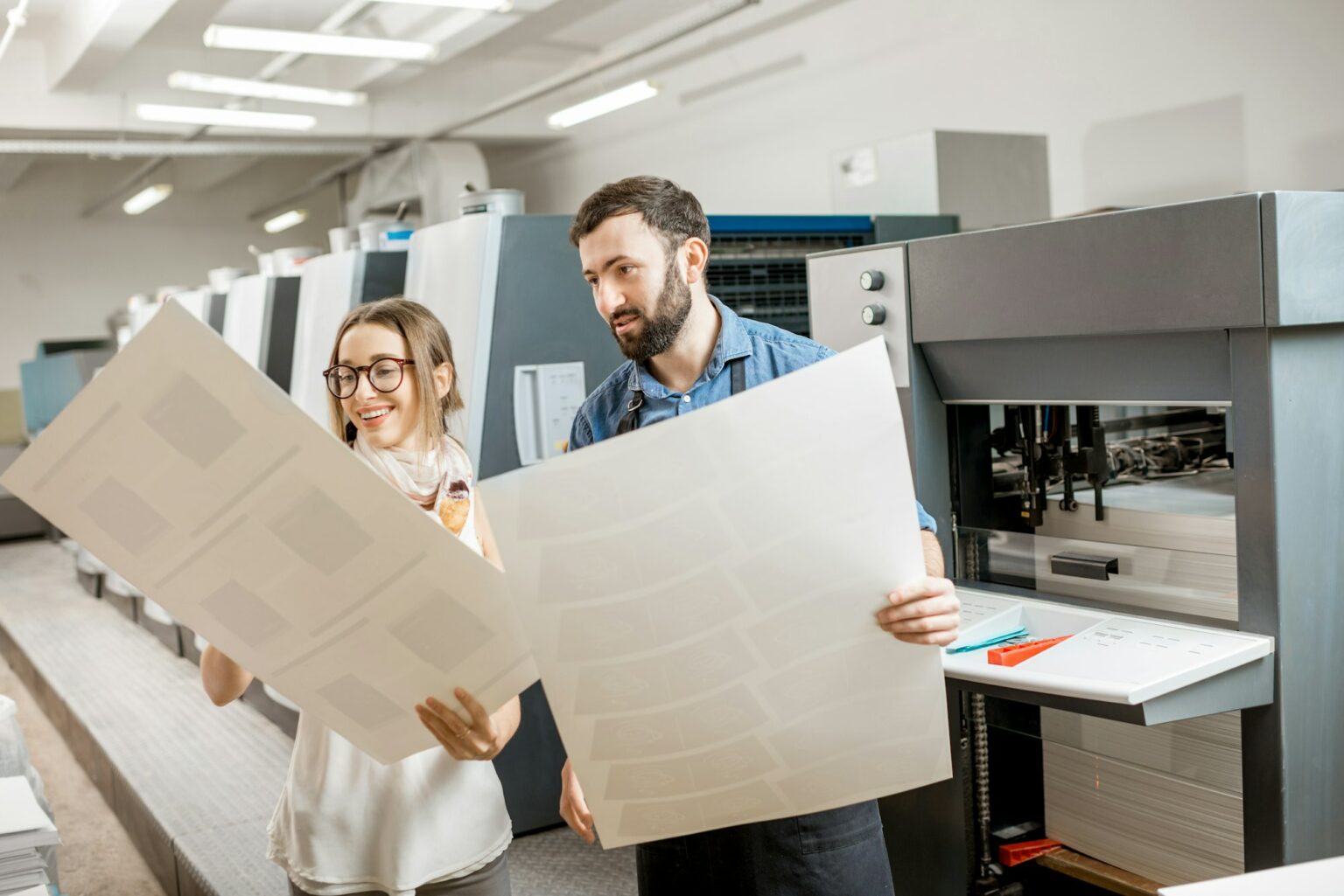 Woman with print operator at the printing manufacturing